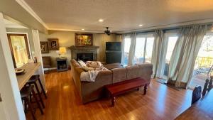 a living room with a couch and a table at Blueberry Bliss Family Retreat on Beaver Lake in Lowell