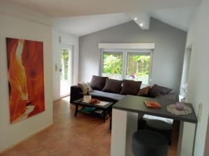 a living room with a couch and a table at Ferienhaus In Im Trieschelbach Mit Großem Garten in Hermeskeil