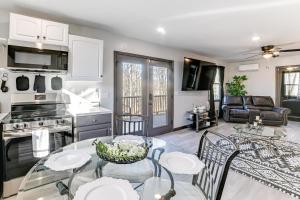 a kitchen and living room with a table and chairs at Kentucky Lake Retreat 4 Mi to Shore Boat and Fish! in New Johnsonville
