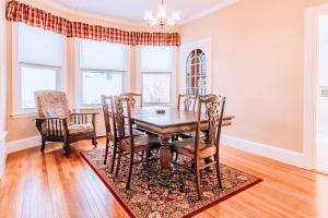 a dining room with a wooden table and chairs at Spotless Victorian on William in Portland