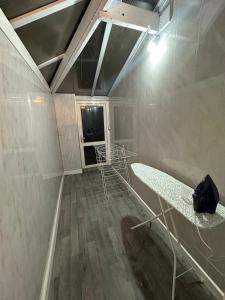 a room with a tub in the middle of a room at Luxury Detached holiday home Near BHX, JLR, NEC in Birmingham