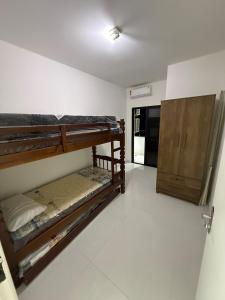 Postel nebo postele na pokoji v ubytování Lindo Apartamento no Guaruja SP