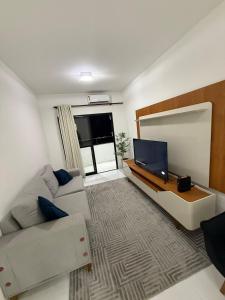 TV a/nebo společenská místnost v ubytování Lindo Apartamento no Guaruja SP