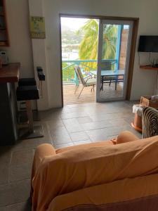 a bedroom with a bed and a view of a deck at CasaCalypso Grenada in Belmont