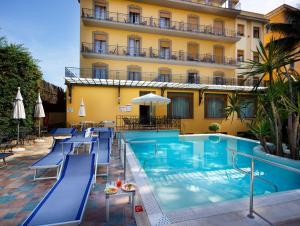 un hotel con piscina frente a un edificio en Hotel Zi' Teresa en Sorrento