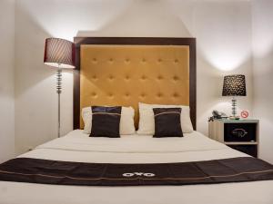 Ένα ή περισσότερα κρεβάτια σε δωμάτιο στο Hotel O Townhouse Oak Grand Orienchi