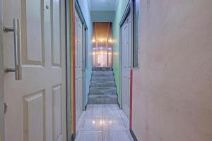 a hallway with a staircase in a building at OYO Life 92877 Hotel Rainbow 7296 in Semarang
