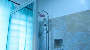a bathroom with a shower with a glass door at Crownedge Hotels in Ikeja +157 photos