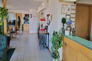 a lobby of a restaurant with a counter and plants at HomeTown Inn By OYO Texhoma, OK in Texhoma