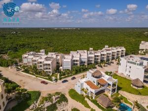 an aerial view of a resort in front of the ocean at Luxurious penthouse by the beach in Akumal