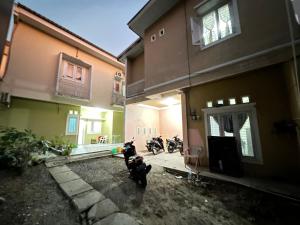 a couple of motorcycles parked outside of a building at Hotel O Anugrah Homestay Syariah in Makassar
