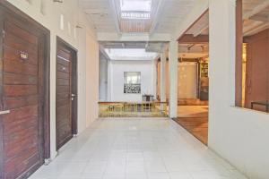 an empty hallway with two doors in a building at Hotel O Kost 99 in Manado