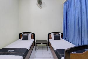 Postel nebo postele na pokoji v ubytování Capital O 93024 Hotel Ganesha