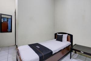 Postel nebo postele na pokoji v ubytování Capital O 93024 Hotel Ganesha