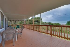 a porch with chairs and a table on it at Falcon's Nest in Twin Rocks