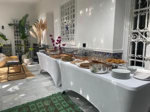 a buffet line with plates of food on it at Dar Kbira - Sidi Bou Said in Sidi Bou Saïd