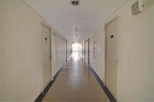 an empty hallway in an office building at OYO Life 92889 Apartement Grand Sentraland Karawang By A.t Room in Karawang +29 photos