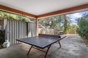 a ping pong table sitting on a patio at Red Gum Beach Retreat in Cowes
