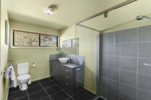 a bathroom with a toilet and a sink and a shower at Red Gum Beach Retreat in Cowes +9 photos