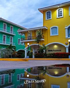 a building with a reflection in a puddle at Casa Bote Con Vista a Los Canales De Lecheria Con Muelle Privado in Las Garzas