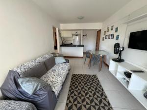 a living room with a couch and a table at Lindo apartamento 1 4 frente mar in Salvador