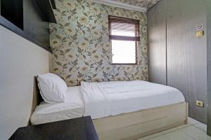 Ένα ή περισσότερα κρεβάτια σε δωμάτιο στο OYO Life 92718 Apartement Gateway Cicadas +16 φωτογραφίες