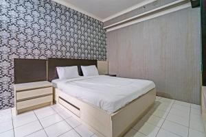 Ένα ή περισσότερα κρεβάτια σε δωμάτιο στο OYO Life 92718 Apartement Gateway Cicadas