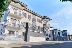 an apartment building with a garage at Queens View Apartment in Accra