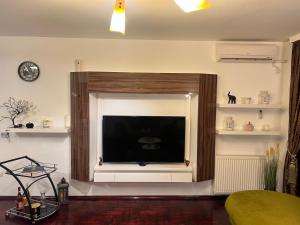 a living room with a large flat screen tv at Mona Lux apartman in Arandelovac