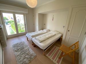 a room with a bed and a window and a door at Family Home near Beach in Golden Triangle in Knokke-Heist