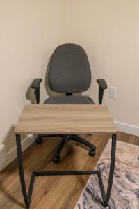 a chair sitting in front of a desk at Modern and Private Guest Suite in Regina, SK in Regina
