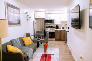 a living room with a couch and a table at Modern and Private Guest Suite in Regina, SK in Regina
