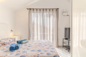 a bedroom with a bed with blue towels on it at Renovated Villa in Las Americas Sea Coast in Playa de las Americas