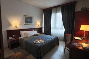 Voodi või voodid majutusasutuse Hotel Leonardo toas
