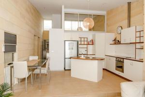 a kitchen and dining room with a table and chairs at Bayview no 2 in Port Campbell