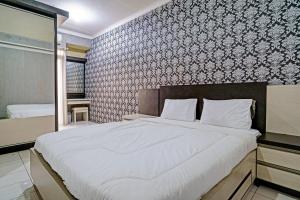 Ένα ή περισσότερα κρεβάτια σε δωμάτιο στο OYO Life 92718 Apartement Gateway Cicadas