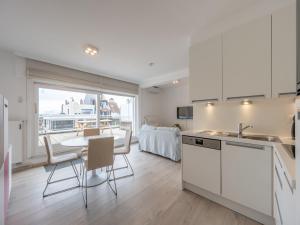a kitchen with a table and a kitchen with a view at Stylish City-View Retreat in Knokke-Heist