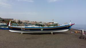 a blue and white boat sitting on the beach at Apartamento Marion in Cala del Moral