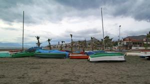 a group of boats sitting on a beach at Apartamento Marion in Cala del Moral