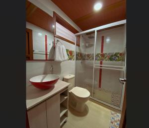 a bathroom with a shower and a sink and a toilet at HOTEL EVOCACIÓN in Buga +17 photos