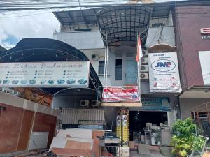 a building with a lot of signs on it at OYO 93090 Multi Plus Inn in Jayapura