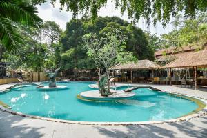 a swimming pool with two statues in the middle at Villa Cha Cha Chaolao Beach Resort in Chao Lao Beach