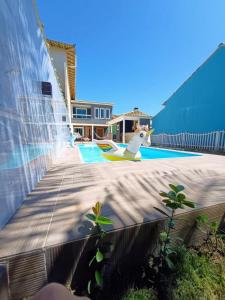 a painting of a swimming pool with a house at Casa com 3 suítes em Cabo Frio com piscina há poucos passos do Mar! in Cabo Frio