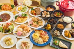 a table with many plates of food on it at Sotetsu Fresa Inn Nihombashi-Ningyocho in Tokyo