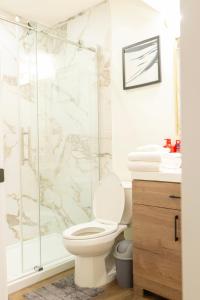 a bathroom with a toilet and a shower at Modern and Private Guest Suite in Regina, SK in Regina