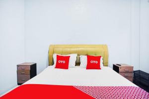 Voodi või voodid majutusasutuse OYO 93071 Home Stay Kembar Syariah toas