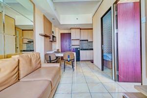 a living room with a couch and a table at OYO Life 93170 Apartement Gateway Cicadas By Mr Pro in Bandung +17 photos
