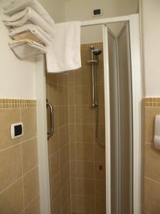 a bathroom with a shower with a white towel at Bed & Breakfast Al Ponte in Scanno