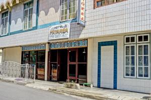 a building on the side of a street with doors at Hotel O Triarga in Takengon