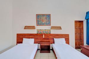 Postel nebo postele na pokoji v ubytování Capital O 93236 Hotel Hapel Negara